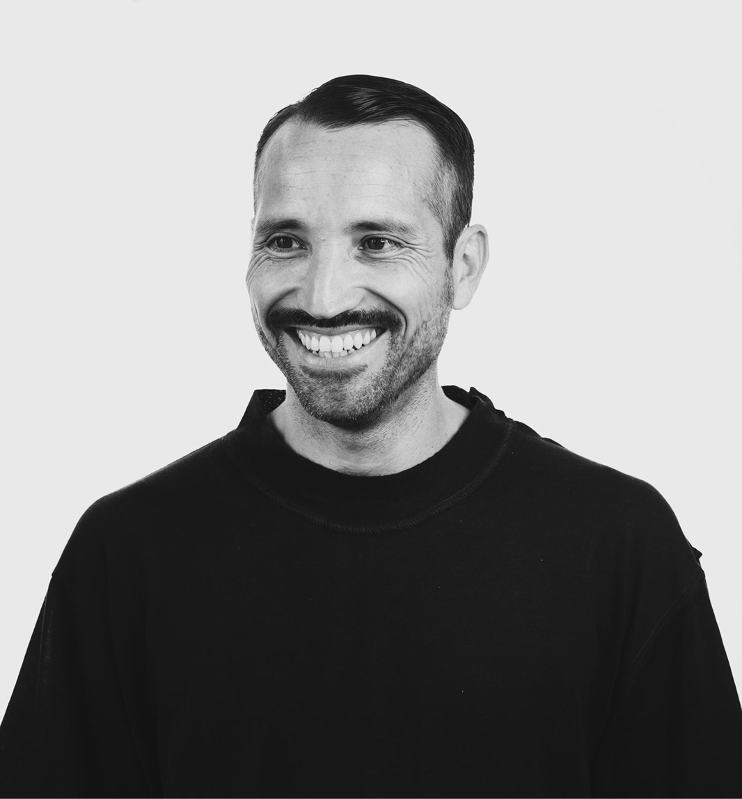 Juan Pablo Castro smiling, wearing a black sweater